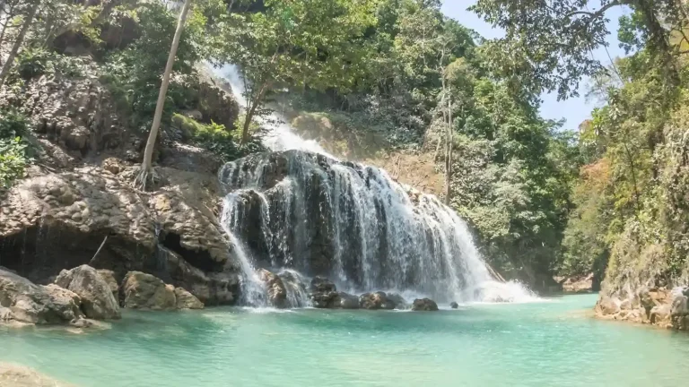 Lapopu Waterfall cascading over limestone terraces into turquoise pools in West Sumba