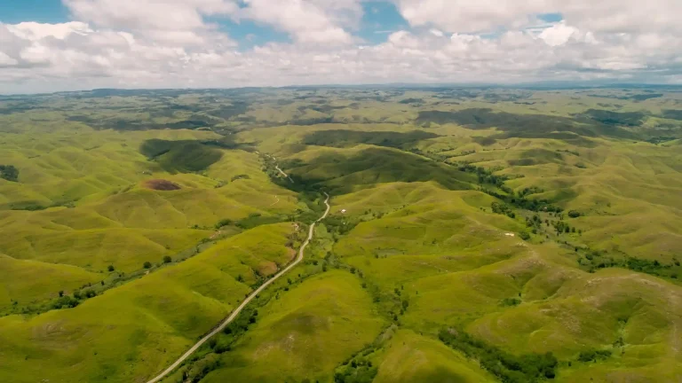 Aerial panorama of the rolling green grasslands around Tanau Hill in East Sumba